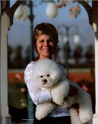 Alison with a white dog in his arms