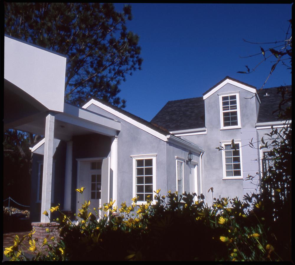 Alcala Pet Care Kennel Building with a flower garden at the front